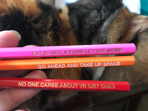 HB pencils that say "Fat is not a four letter word" "Go ahead and take up space" and "No one cares about yr diet Chad"