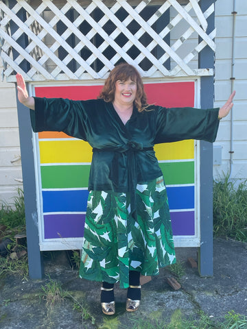 Rebecca wears a bottle green CAITLIN cardigan and banana leaf TIARE skirt
