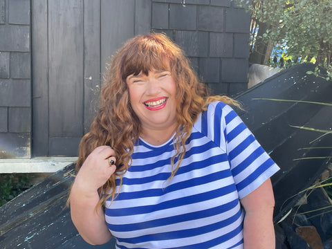 Rebecca wears the blue and white striped KRIS dress