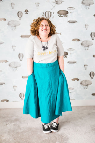 Short girl in bright turquoise skirt
